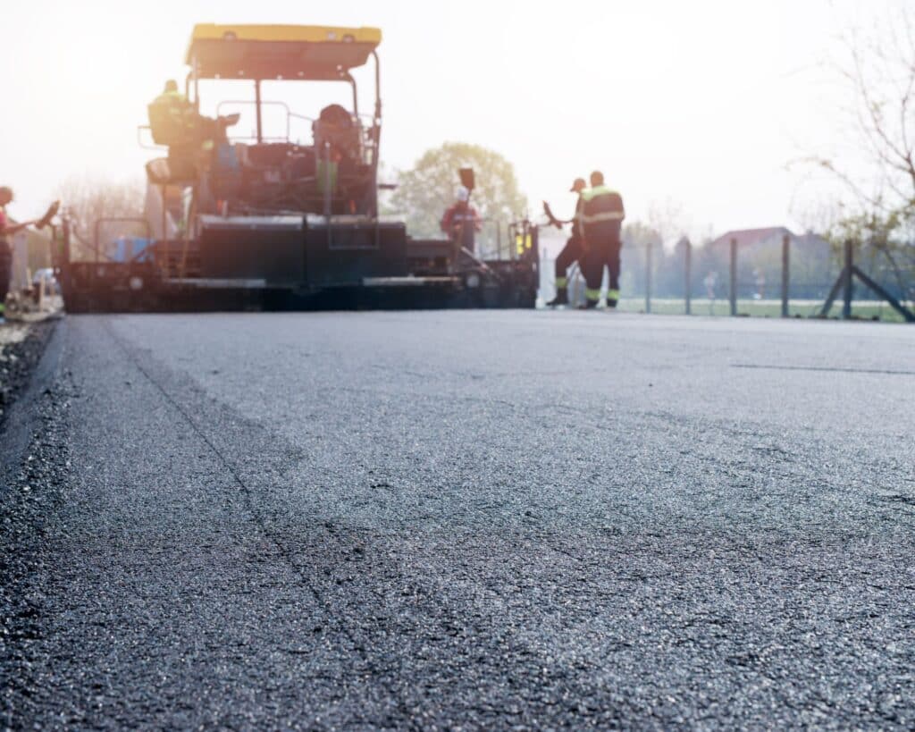 workers-placing-new-coating-asphalt-road (1) (1)